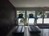 Bright fitness room featuring two modern treadmills with a view of the inviting outdoor pool.