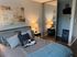 Elegant bedroom featuring modern decor with a cozy bed, stylish pillows, and a large mirrored closet.