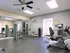 Fitness Center: large mirror, exercise machines, ceiling fan, natural light.