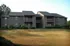 Charming two-story apartment complex with balconies and natural surroundings.