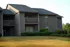 Elegant suburban apartment complex with lush landscaping and private balconies.