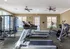 Bright and spacious fitness center with modern exercise equipment in a luxury apartment complex.