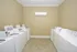Bright and spacious laundry room featuring modern washers and dryers with tiled flooring.
