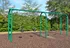 Inviting playground area featuring a classic swing set surrounded by lush green trees.