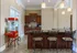 Leasing Office - kitchen area with a stylish bar counter, elegant chairs, and a vibrant popcorn machine.
