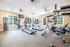 Bright and spacious gym with modern exercise equipment and large windows.
