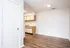 Inviting kitchen with wooden flooring, white cabinetry, and ample natural light.
