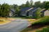 Charming suburban neighborhood with well-maintained apartment buildings and lush greenery.