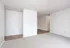Bright and open living space with textured carpeting and sleek wood flooring.