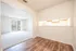 Charming apartment featuring a bright living room with carpet, a separate area with wood flooring, and a view of the outdoors.