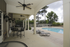 Chic outdoor area featuring a poolside view with comfortable seating and modern ceiling fans.