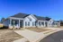 Row of charming blue villas with modern design features and neatly paved sidewalks.