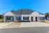 Elegant duplex with modern design, featuring a blue and white facade and tidy landscaping.
