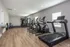 Modern gym facility featuring treadmills, elliptical trainers, and strength training equipment.