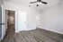 Bright and airy bedroom with elegant hardwood flooring and contemporary ceiling fan.