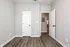 Bright room with elegant laminate flooring and white paneled doors.
