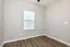 Bright room with sleek wood flooring and modern window blinds.