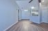 Contemporary living space with elegant wood flooring and a sleek open kitchen design, perfect for modern living.