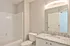 Elegant bathroom with sleek granite countertop, modern vanity, and pristine bathtub; perfect blend of style and functionality.