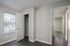 Bright, spacious bedroom featuring sleek hardwood floors, ample closet space, and a large window offering natural light.