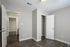 Bright, modern bedroom with sleek hardwood floors and spacious closet in an elegant apartment.