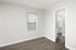 Bright and inviting corner room with elegant wood flooring, neutral walls, and abundant natural light from large windows.