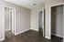 Bright and inviting room with elegant wood flooring, open closet space, and modern doors perfect for a stylish home.