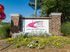 Inviting entrance sign for Campus Side Apartments, surrounded by colorful flowers and lush greenery, offering quality off-campus housing.
