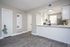 Modern open-concept kitchen with sleek cabinetry and stylish flooring, ideal for contemporary living.
