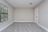 Bright and spacious room with fresh carpet and neutral walls, featuring a large window perfect for natural light.