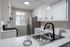 Chic kitchen with sleek stainless steel appliances, elegant countertops, and ample natural light.