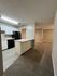 Inviting kitchen and living area with modern finishes, featuring sleek countertops, stylish cabinetry, and an open layout for seamless living.