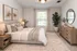 Inviting bedroom with plush bedding, chic decor, large window, and elegant dresser, creating a serene retreat.