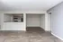 Modern open-concept living space featuring sleek hardwood floors and a stylish kitchen area.
