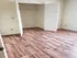 Bright and inviting bedroom with elegant hardwood flooring and a spacious closet.