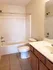 Bright and inviting bathroom featuring a modern bathtub, sleek vanity, and elegant tile flooring.