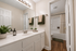 Elegant bathroom with a modern vanity, stylish fixtures, and soothing beige tones, offering a serene retreat.