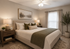 Elegant bedroom with a cozy beige bed, stylish green accents, soft lighting, and serene artwork.