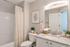 Elegant bathroom featuring a granite countertop, modern fixtures, and tasteful decor plants for a serene ambiance.