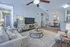Inviting open-concept living room with cozy seating, elegant decor, and a modern dining area, perfect for entertaining.