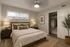 Cozy bedroom with elegant decor, featuring a queen-sized bed, soft lighting, and a spacious open closet.
