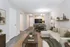 Chic living room with modern decor, cozy sectional sofa, and elegant dining area leading to a compact kitchen.