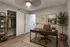 Chic home office featuring a modern wooden desk, sleek shelving, and elegant decor in a tranquil setting.