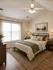 Inviting bedroom with large window, comfortable bed, and elegant decor, perfect for relaxation.