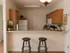 Charming kitchen with warm wood cabinets, inviting breakfast bar, and modern appliances, perfect for cozy gatherings.