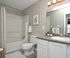 Modern bathroom with sleek fixtures, decorative greenery, and elegant lighting, offering a refreshing and serene atmosphere.