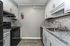 Modern kitchen with elegant granite countertops, sleek white cabinets, and hardwood flooring, perfect for culinary creativity.