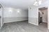 Inviting apartment living area with elegant wood flooring, modern lighting, and a cozy kitchen nook.