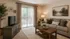 Inviting living room with elegant decor, comfortable sofa, and large sliding glass doors opening to a serene balcony view.