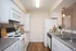 Bright and inviting kitchen with modern appliances, ample cabinetry, and a sleek dual sink, perfect for culinary enthusiasts.